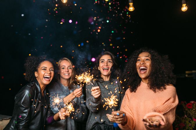 Multi-ethnic group of happy women with sparklers