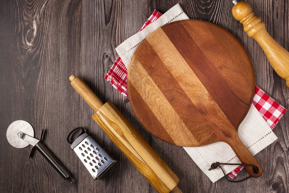 Empty pizza board on rustic wooden table. Top view image.