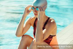 Female in swimwear adjusting her swim goggles 5nBxQ5