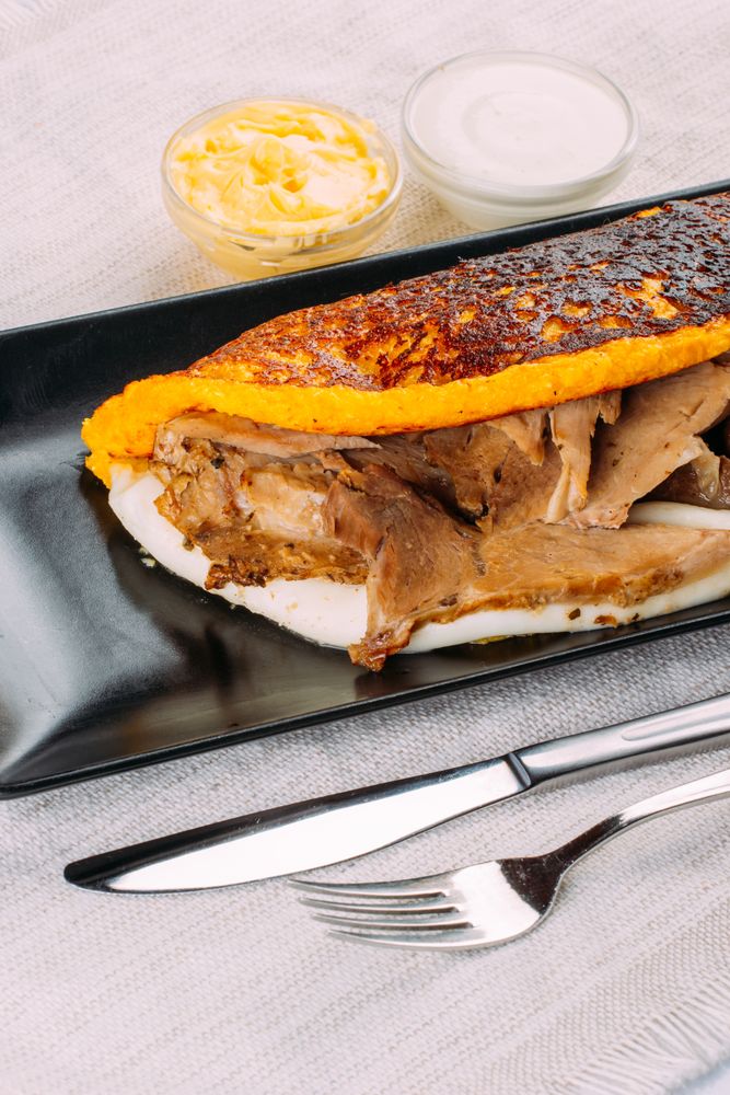 Cachapa, typical Venezuelan dish made with corn and stuffed with cheese and pork