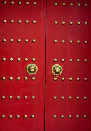 Red door with lion heads