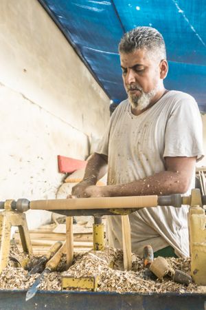 Man using woodworking machine at workplace