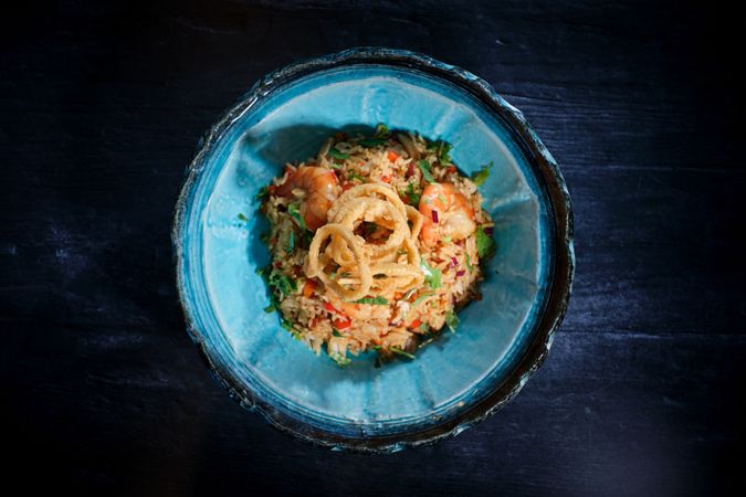 Bowl of delicious fried rice with shrimps on table