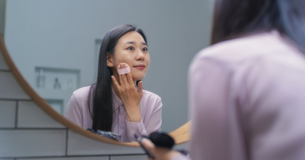 South Korean Female Putting on Makeup in a Bathroom at Home.