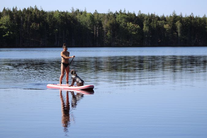 Woman and dog on a kayak in a lake