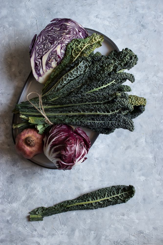 Pomegranate near red cabbage and kale