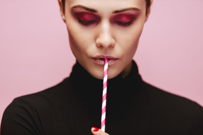 Beautiful female model with a straw