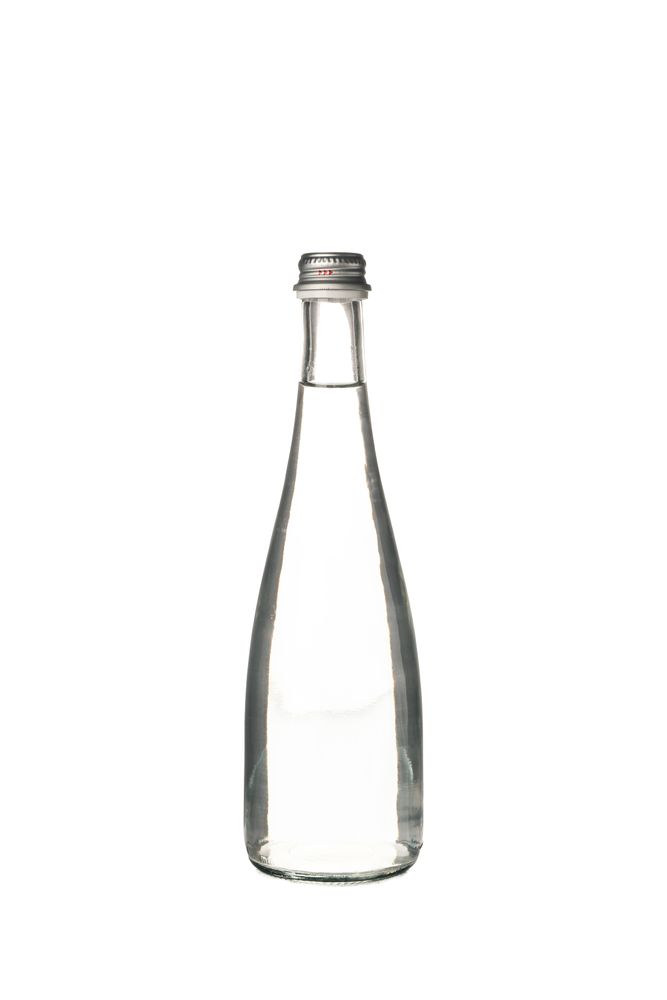 Glass water bottle in plain room