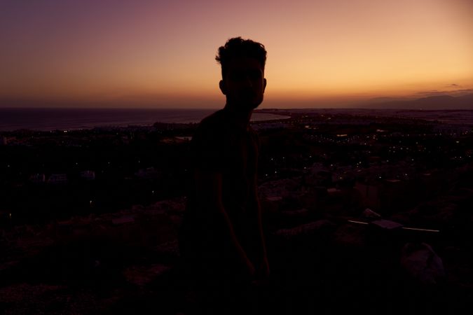 Silhouette of male enjoying picturesque sunset