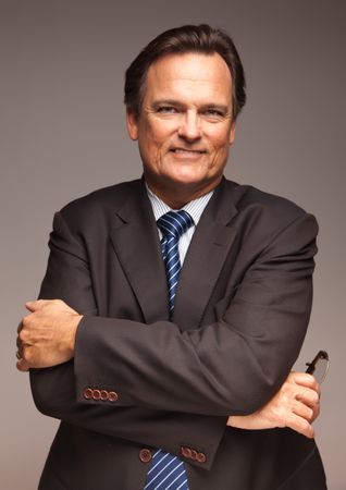 Professional Portrait of Confident Businessman on Grey Background