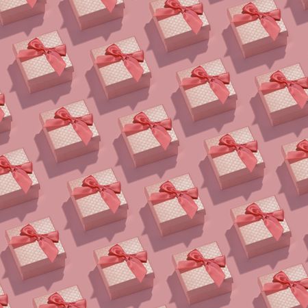 Pattern made of pink gift boxes on pastel background