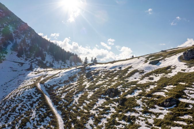 Drone shot of snowy pasture in autumn in the Bavarian Alps