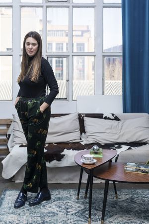 Long haired woman standing in living room at home