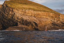 Woman on paddleboard floating in sea