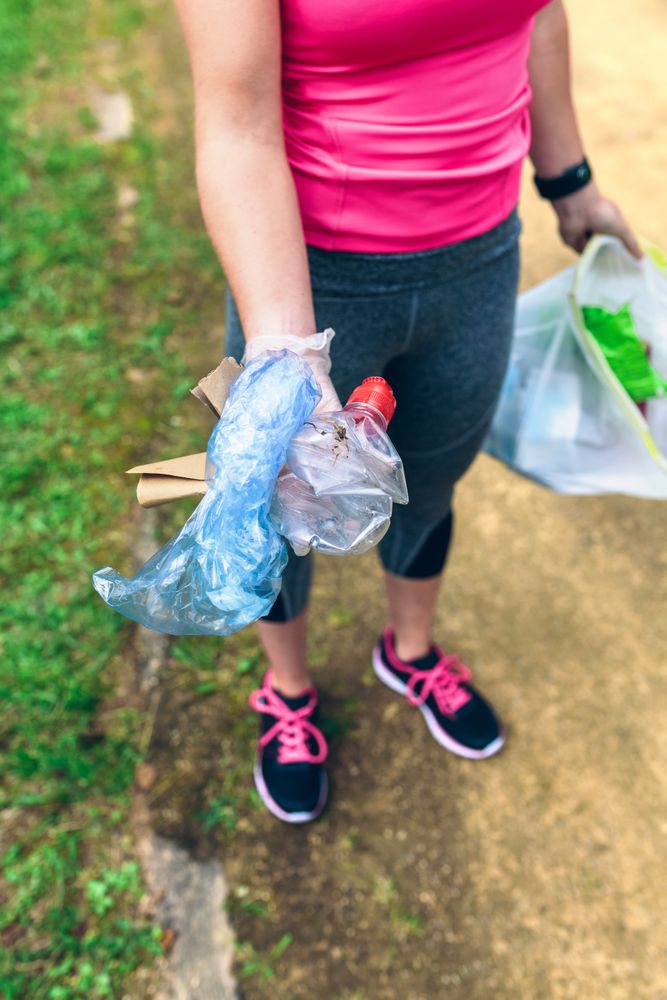 Unrecognizable female showing garbage she has collected