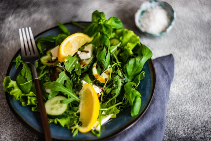 Fresh green salad with lemon slices