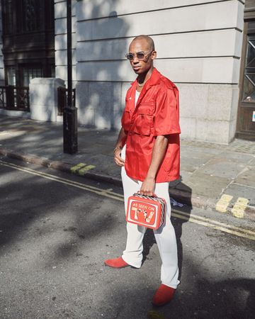London, England, United Kingdom - September 15th, 2019: Man posing on street with trendy bag
