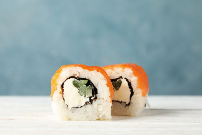 Delicious sushi rolls on wooden table, close up. Japanese food