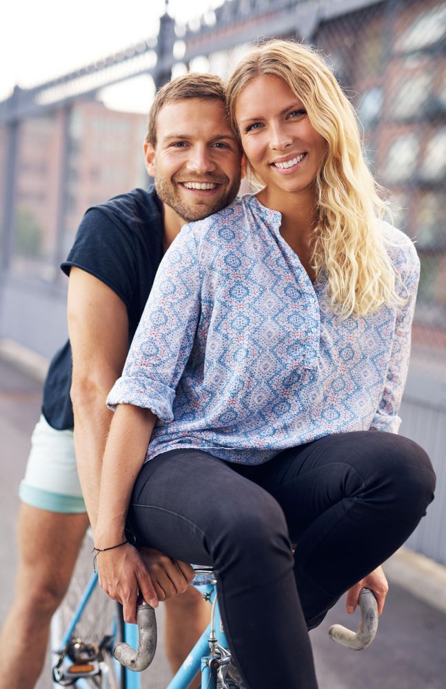 Portrait of happy couple on bicycle
