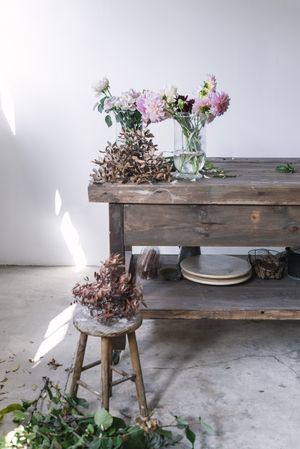 Bunches of flowers in vases on table