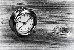 Retro clock on aged wood desk table