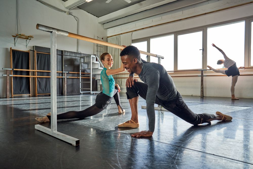 Couple of two dancers in a class doing a training in ballet academy