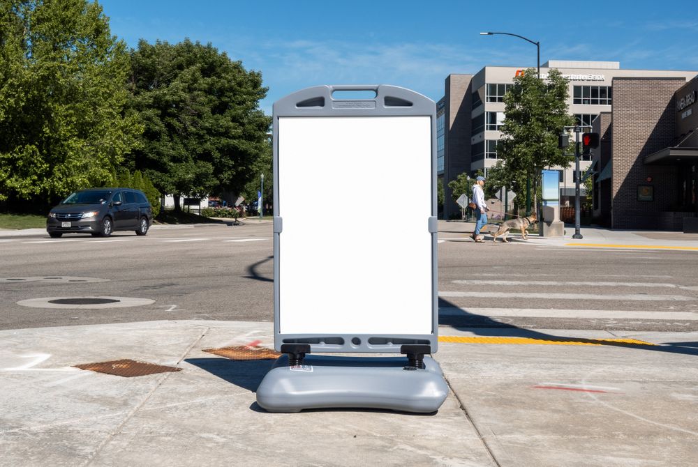 Plastic poster mockup on street beside crosswalk