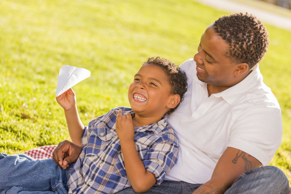 Father and Son Playing with Paper Airplanes