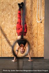 Fit woman performing handstand exercise in the gym 0v37vx