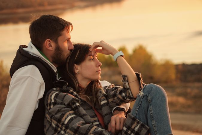 Couple sitting dusk countryside
