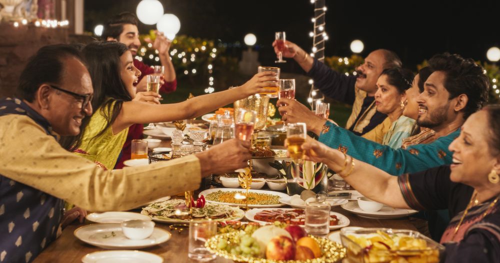 Big Family Celebrating Diwali: Indian Family in Traditional Clothes Gathered Together on a Dinner Table