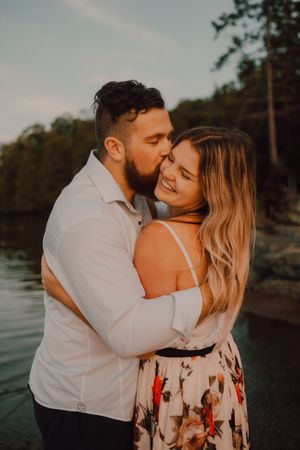 Loving couple standing ankle deep in water on beach