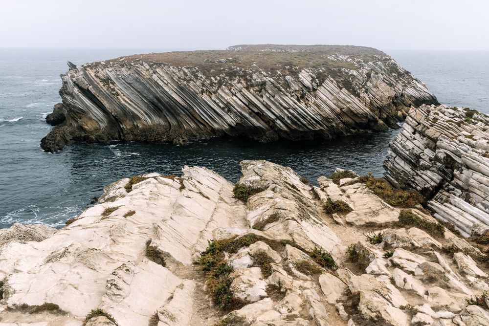 Rocky formations in the island of Baleal on the Atlantic coast in a foggy day. Peniche, Portugal