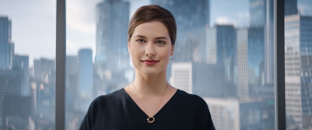 Close Up Portrait of White Businesswoman Posing Next to Window in Big City Office with Skyscrapers.