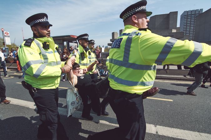London, England, United Kingdom - April 19th, 2019: British police carrying protestor through street