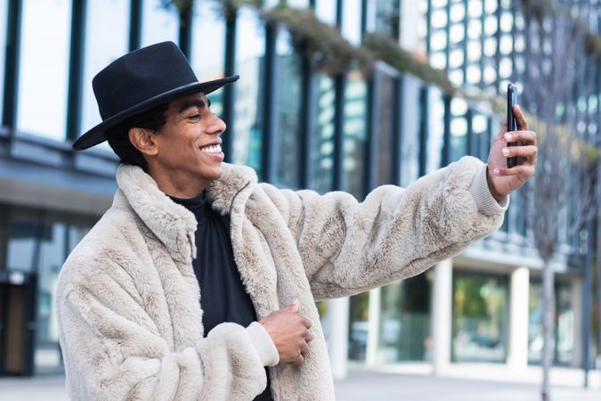 Stylish man taking selfie on smartphone