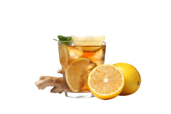 A glass of cold tea with orange and ginger, isolated on plain background