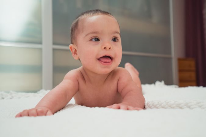 baby lying on bed