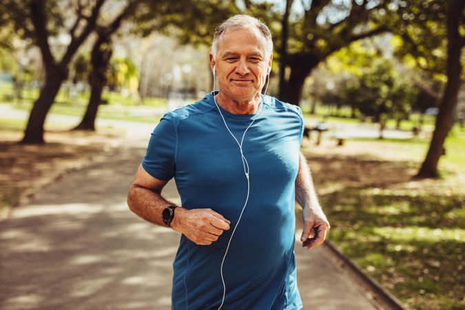 Fit older male running in park for good health