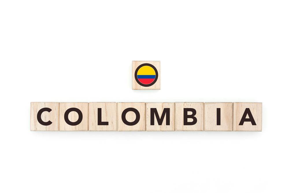 Wooden blocks bearing the name and flag of Colombia. Colombian and South American Culture, national identity, travel, and geography in a copy space design.