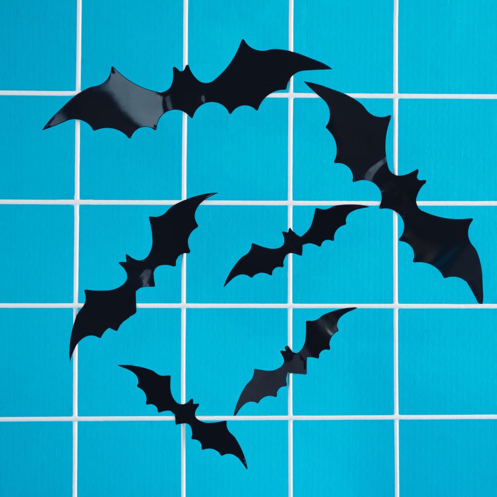 Bats flying around on a sky blue background