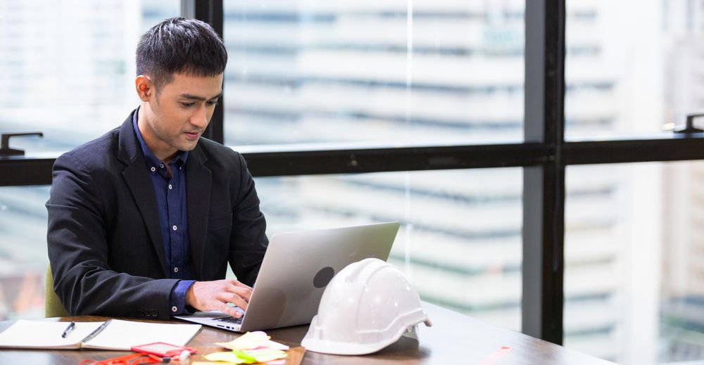 Man concentrating on his work on laptop in office