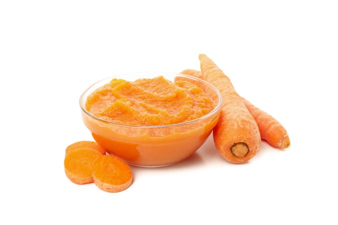 Bowl with healthy baby food isolated on plain background