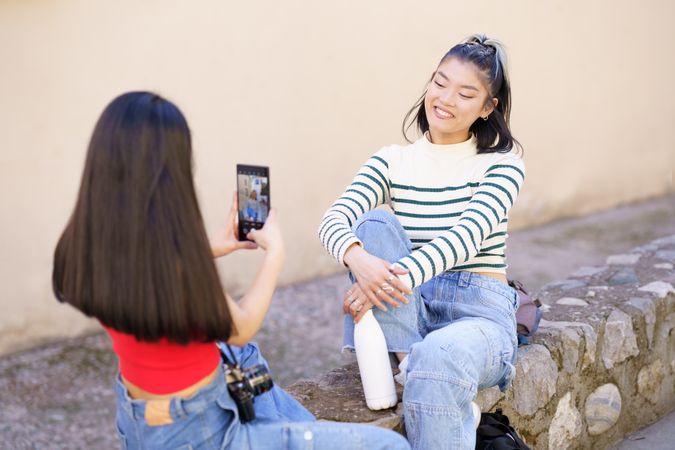 Woman smiling while her friend takes her picture