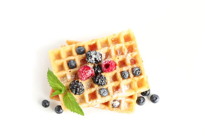 Waffles with berries and mint isolated on blank background