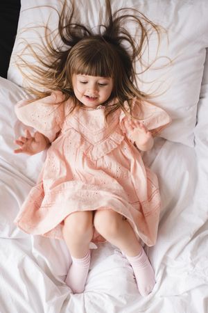 Cute baby girl in bed in room closeup