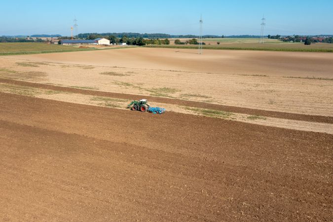 Drone aerial view of a tractor working an agricultural field in Germany