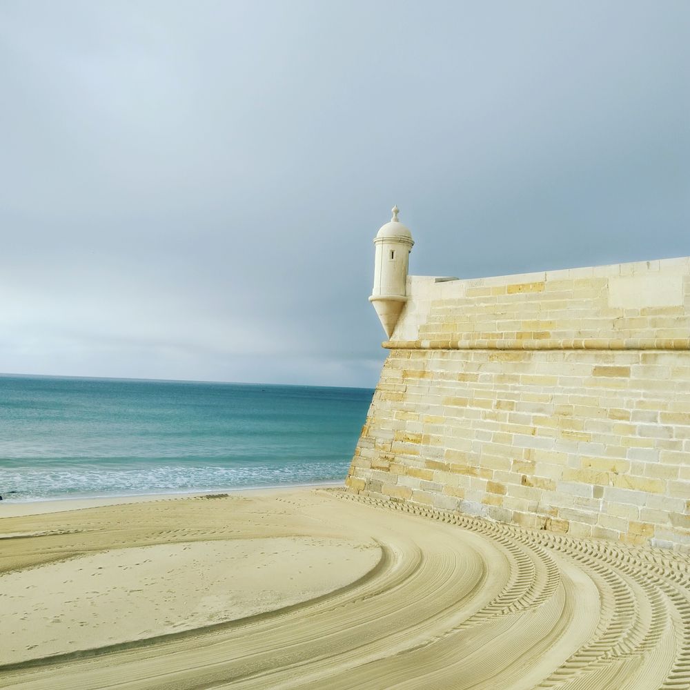 Light concrete building near sea