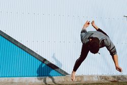 Trendy male flipping on street
