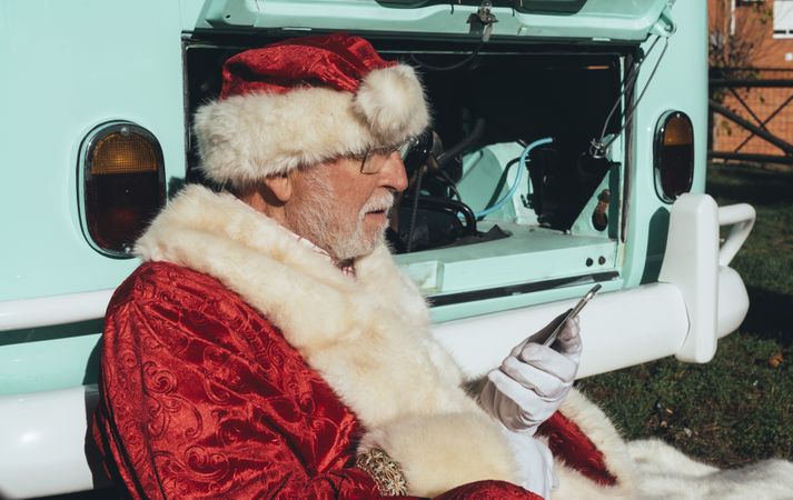 Santa Claus resting by old van